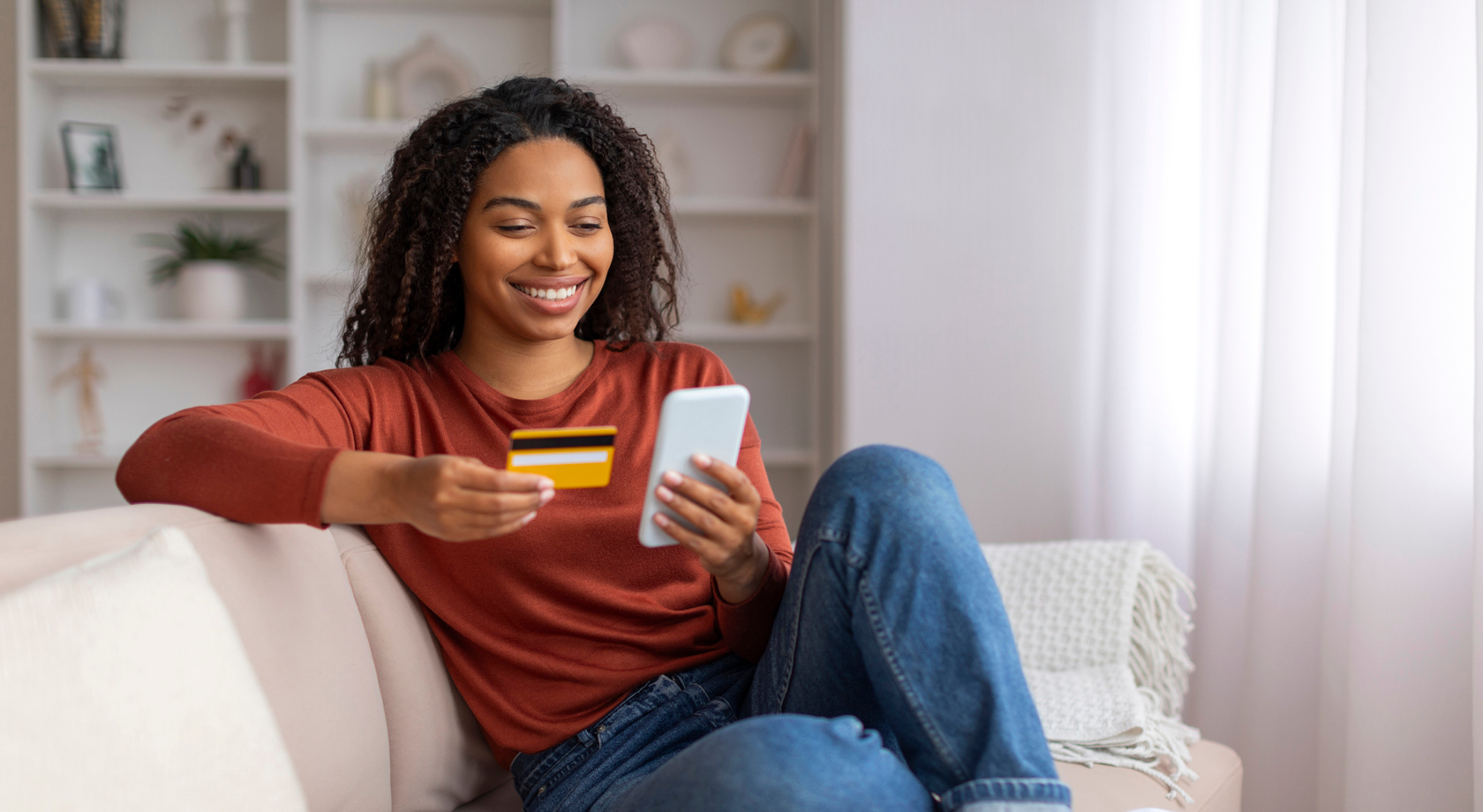 Woman online shopping on phone with debit card